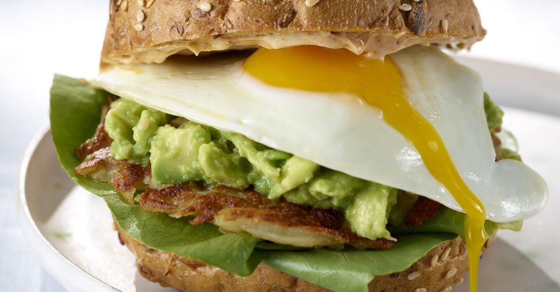 Fried egg burgers with smashed avocado, crispy potato pancake and smoked  paprika sauce